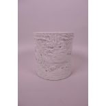 A Chinese blanc de chine brush pot with relief decoration of dragons and carp, impressed seal mark