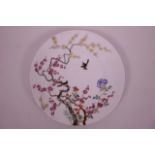 A Chinese polychrome porcelain saucer/cabinet plate decorated with birds amongst a tree in bloom,