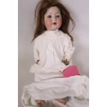 A German 'Otto Reinecke' ceramic doll marked P.M., number 914 with closing eyes and two teeth having