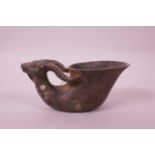 A Chinese archaic style bronze libation cup with deer head handles, impressed seal mark to base,