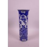 A Chinese blue and white porcelain cylinder vase with decorative panels depicting birds amongst