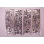 A set of four Chinese white metal scroll weights decorated with figures in a garden, 6" x 2"