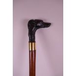 A polished wood walking stick with bronzed composition handle in the form of a greyhound, with brass