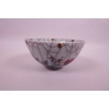 A Chinese crackle ground pottery rice bowl, with blue and red prunus blossom decoration, 5½"
