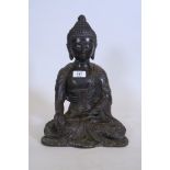 A bronze figure of Buddha, seated in a lotus position, 13½" high