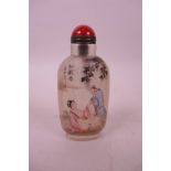 A Chinese reverse painted glass snuff bottle decorated with an erotic scene, character inscription