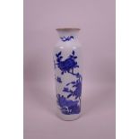 A Chinese blue and white cylinder vase decorated with birds and butterflies, 9½" high