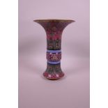 A Chinese gu shaped polychrome porcelain vase with enamelled floral decoration on a pink ground,