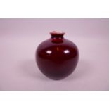 A Chinese sang de boeuf ground pomegranate vase, 3" high