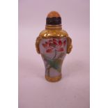 A Chinese Peking glass snuff bottle with gilt and enamelled decoration of lotus flowers and birds, 4