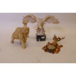 A composition figure of an eagle on a marble base, 9" wide, another of an elephant, and a