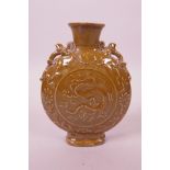 A Chinese brown glazed, pottery moon flask with two dragon handles and raised dragon decoration,