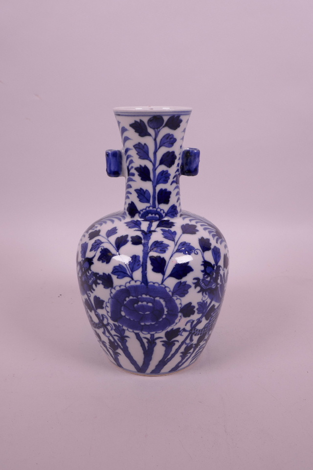 A Chinese blue and white porcelain vase with two lug handles, decorated with dragons and flowers,