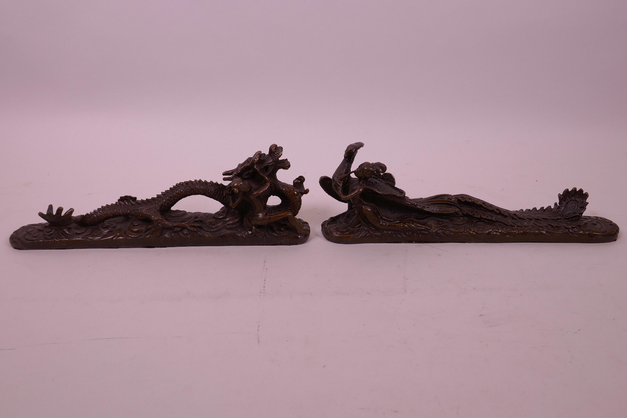 A pair of Chinese scroll weights in the form of a dragon and phoenix, 8½" long