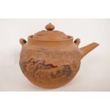 A Chinese Yixing red earthenware teapot with carved and embossed decoration of a dragon, 5" high