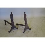 A pair of cast iron fire dogs in the form of classical figures, A/F, 15½" long, 14½" high