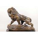 A large pottery figure of a male lion, 19" long, 15" high