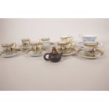 A set of six Japanese porcelain cups and saucers painted with figures in a garden, together with a