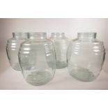 A set of four glass barrels, formerly night lights to the Barbican, 13" high