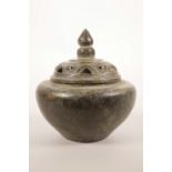 An Oriental bronze censer and pierced cover with a verdigris patina, 4½" high