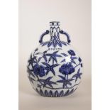 A Chinese blue and white pottery two handled moon flask decorated with flowers in bloom, 6 character