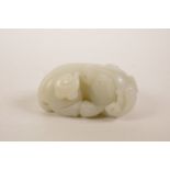 A Chinese celadon jade ornament carved in the form of a buffalo, 2½" long