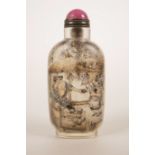 A Chinese reverse painted glass snuff bottle decorated with figures in a tea house, character