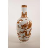 A Chinese red and white porcelain vase decorated with dragons chasing the flaming pearl with gilt