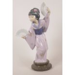 A Lladro porcelain figurine of a Japanese geisha dancing with two fans, model 4991, 12" high