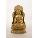 A Sino-Tibetan gilt bronze Buddha seated on a throne, 9" high