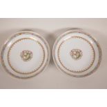 A pair of late C19th/early C20th Chinese porcelain shallow dishes with armorial crests within