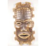 An African carved wood 'tribal mask' wall plaque, 26" long