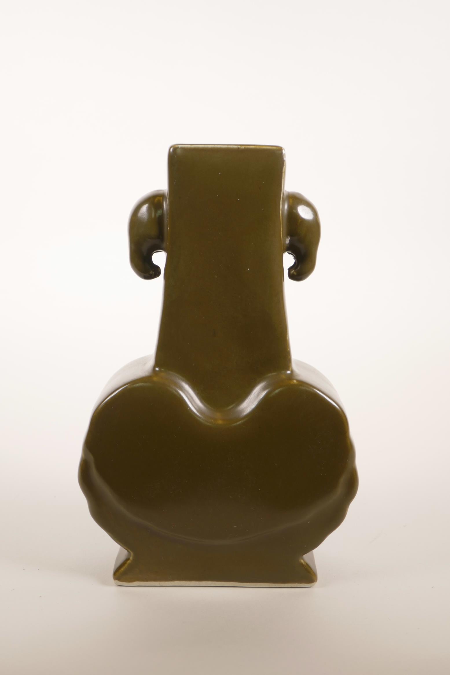 A Chinese tea dust glazed pottery vase with two elephant head handles, 6 character mark to base,