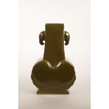 A Chinese tea dust glazed pottery vase with two elephant head handles, 6 character mark to base,