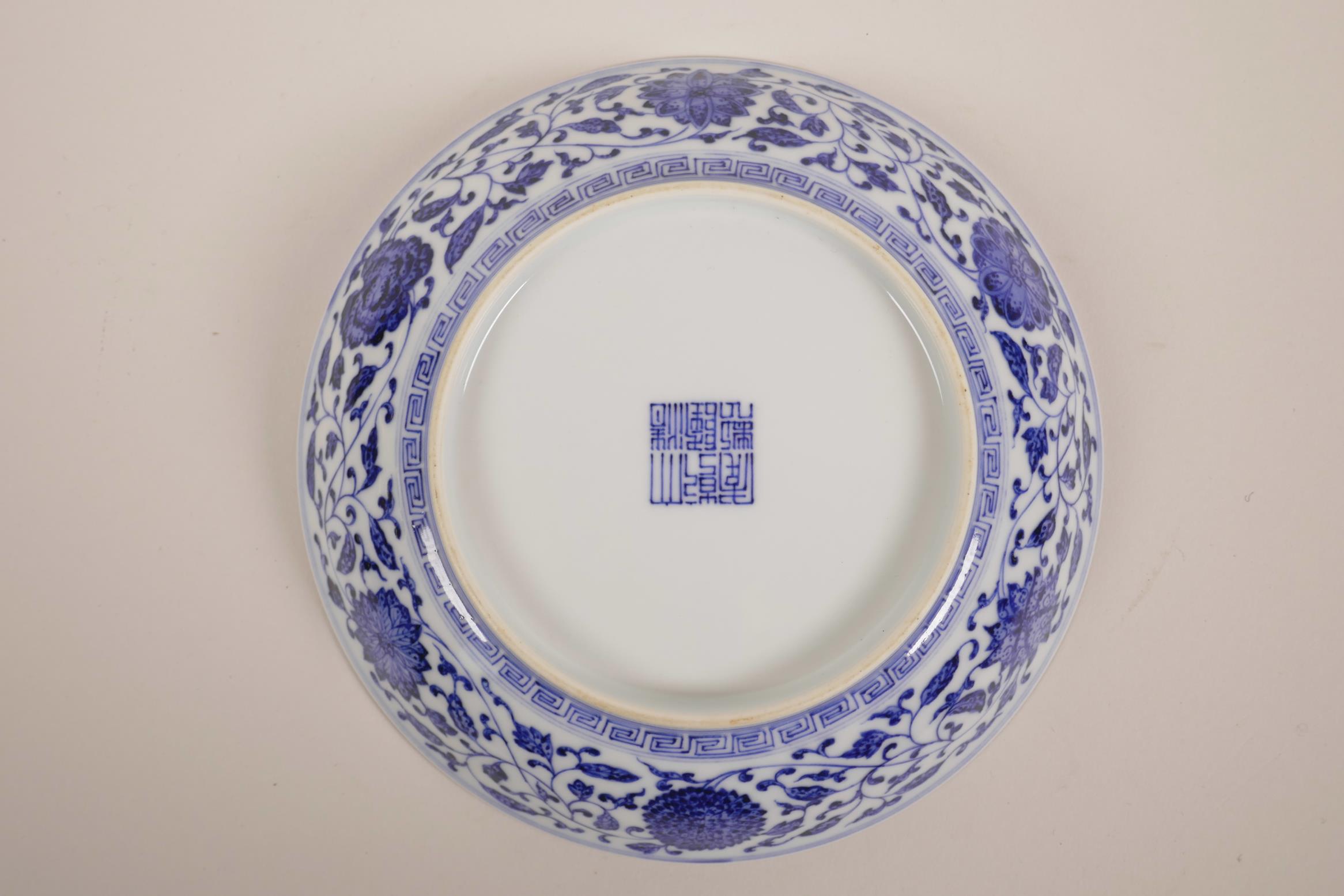 A Chinese blue and white porcelain shallow dish with scrolling floral decoration, seal mark to base, - Image 2 of 3