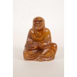 A Chinese amber soapstone seal carved in the form of Buddha, 3½" high