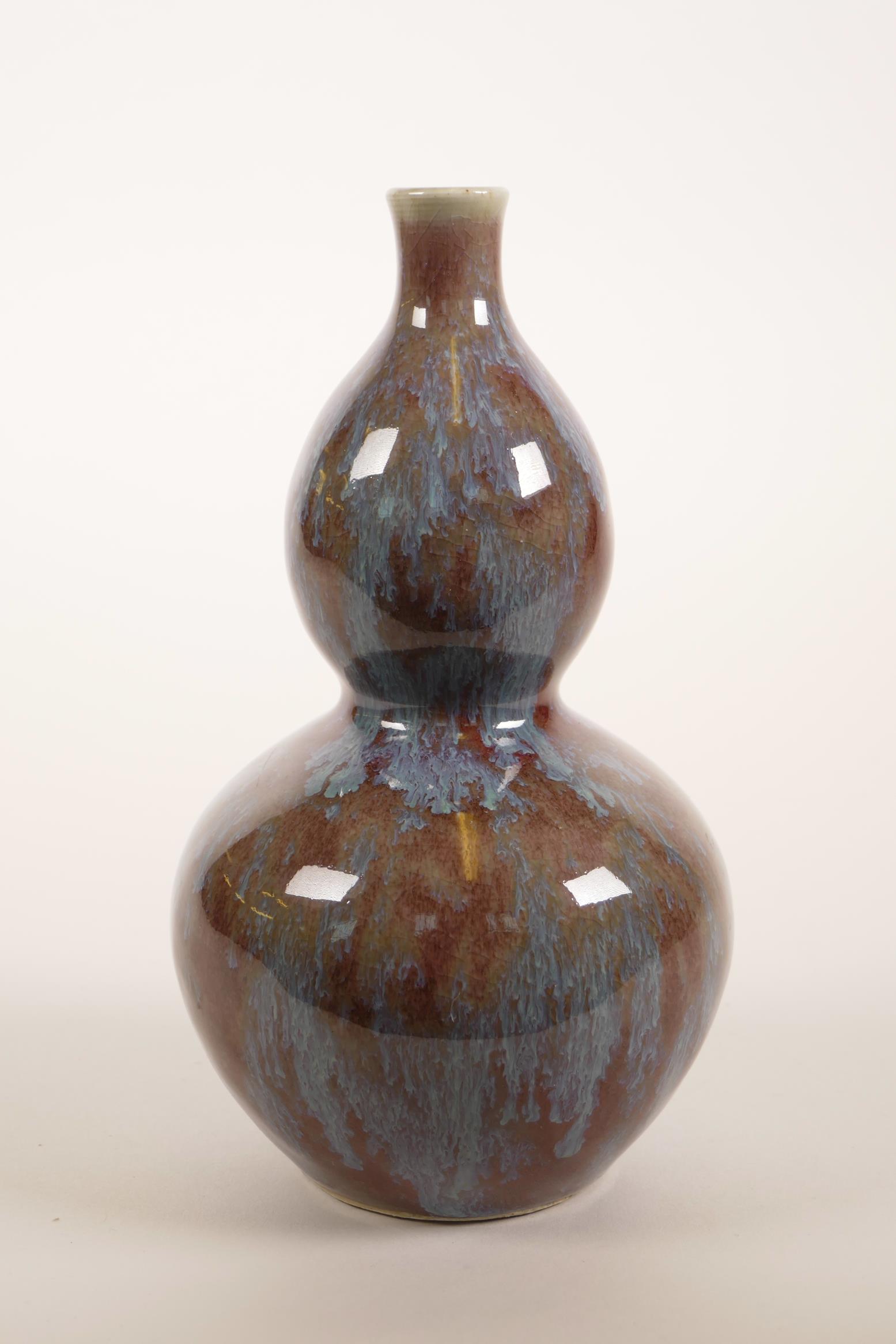 A Chinese double gourd pottery vase with a teal and burgundy glaze, 7½" high