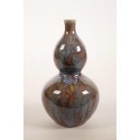 A Chinese double gourd pottery vase with a teal and burgundy glaze, 7½" high