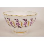 A rare C18th Worcester porcelain tea bowl of whorl pattern painted with flowers and gilt