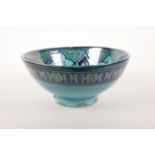 A North African blue glazed pottery bowl of Moorish design, script to base, 9" diameter