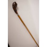 A Malacca walking stick with hardwood handle carved as fruit, and metal collar, 34½" long