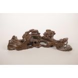 A Chinese carved hardwood brush rest in the form of a tree root, 8" long