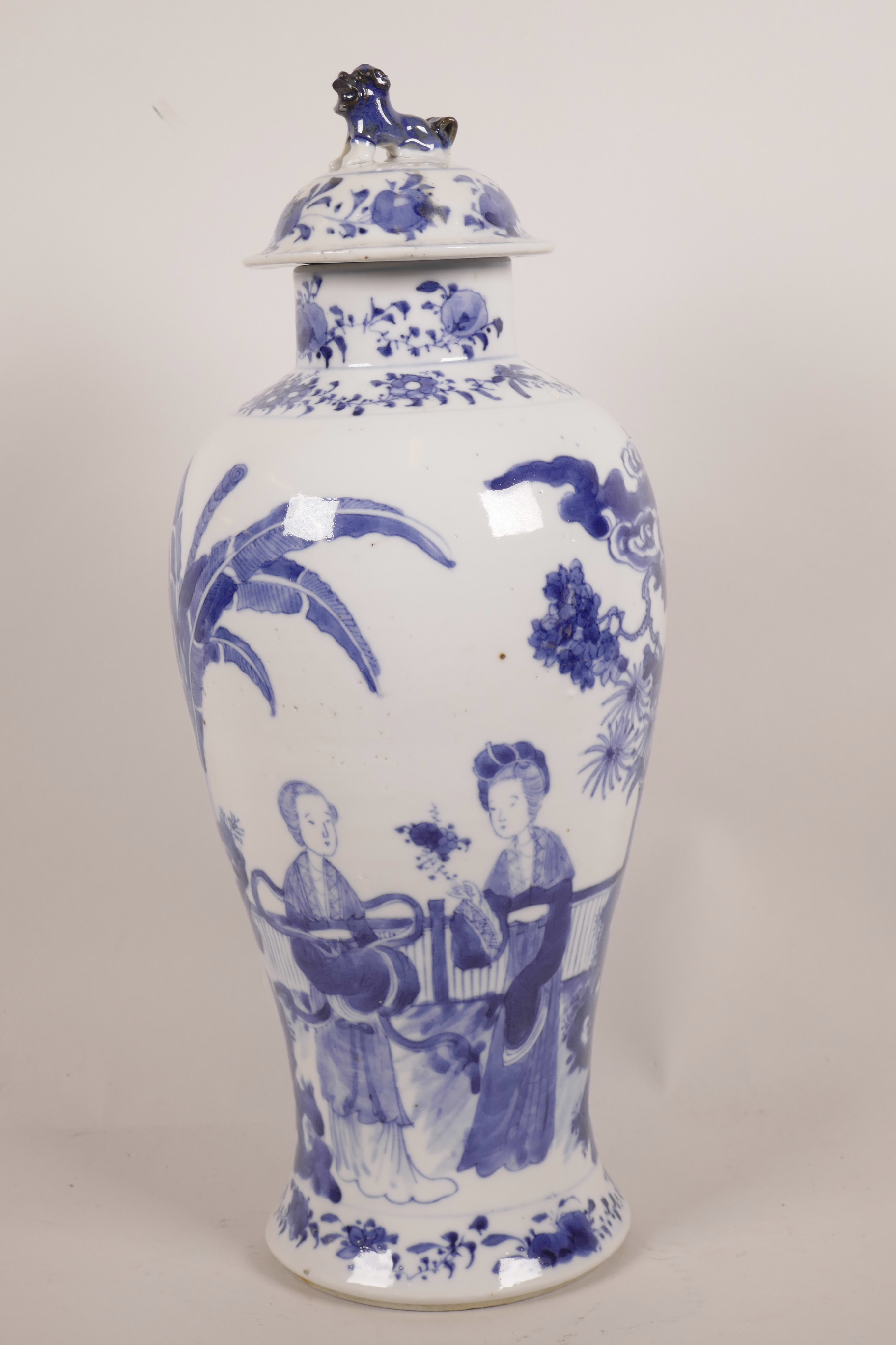 A C19th Chinese blue and white porcelain baluster vase and cover decorated with female figures in