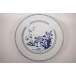 A C19th Chinese blue and white porcelain charger decorated with a bird and rabbit amongst