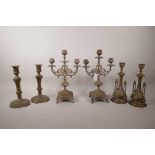 A pair of bronze three branch candlesticks, together with two other pairs of candlesticks, largest