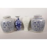 A pair of Chinese blue and white porcelain dry storage jars and covers, 9½" high, together with