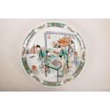 A Chinese famille verte porcelain charger decorated with ladies at leisure, 6 character mark to