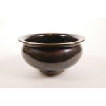 A Chinese porcelain rice bowl with a deep brown mirror glaze, 6 character mark to base, 5½" diameter