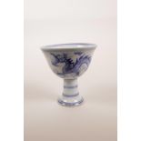 A Chinese blue and white porcelain stem cup decorated with a dragon chasing the flaming pearl, 6