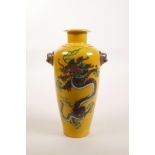 A Chinese Sancai porcelain vase with two mask handles, decorated with a five toed dragon, 8" high